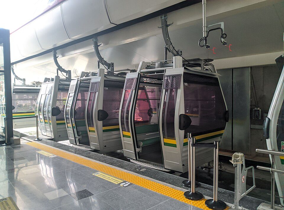 Modern Metrocable gondola cabins lined up at a clean, covered station platform in Medellín